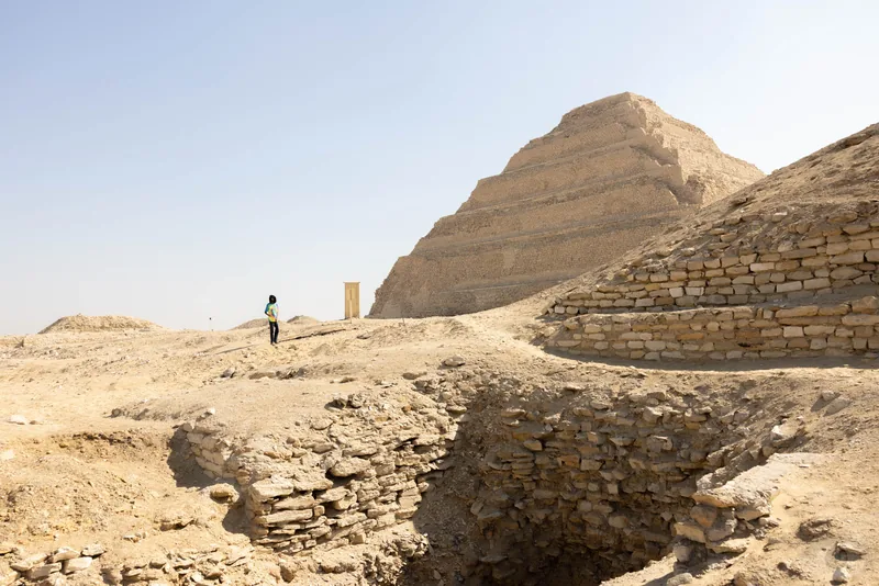 The stepped limestone pyramid of Djoser rising above the ruined enclosure walls of Saqqara