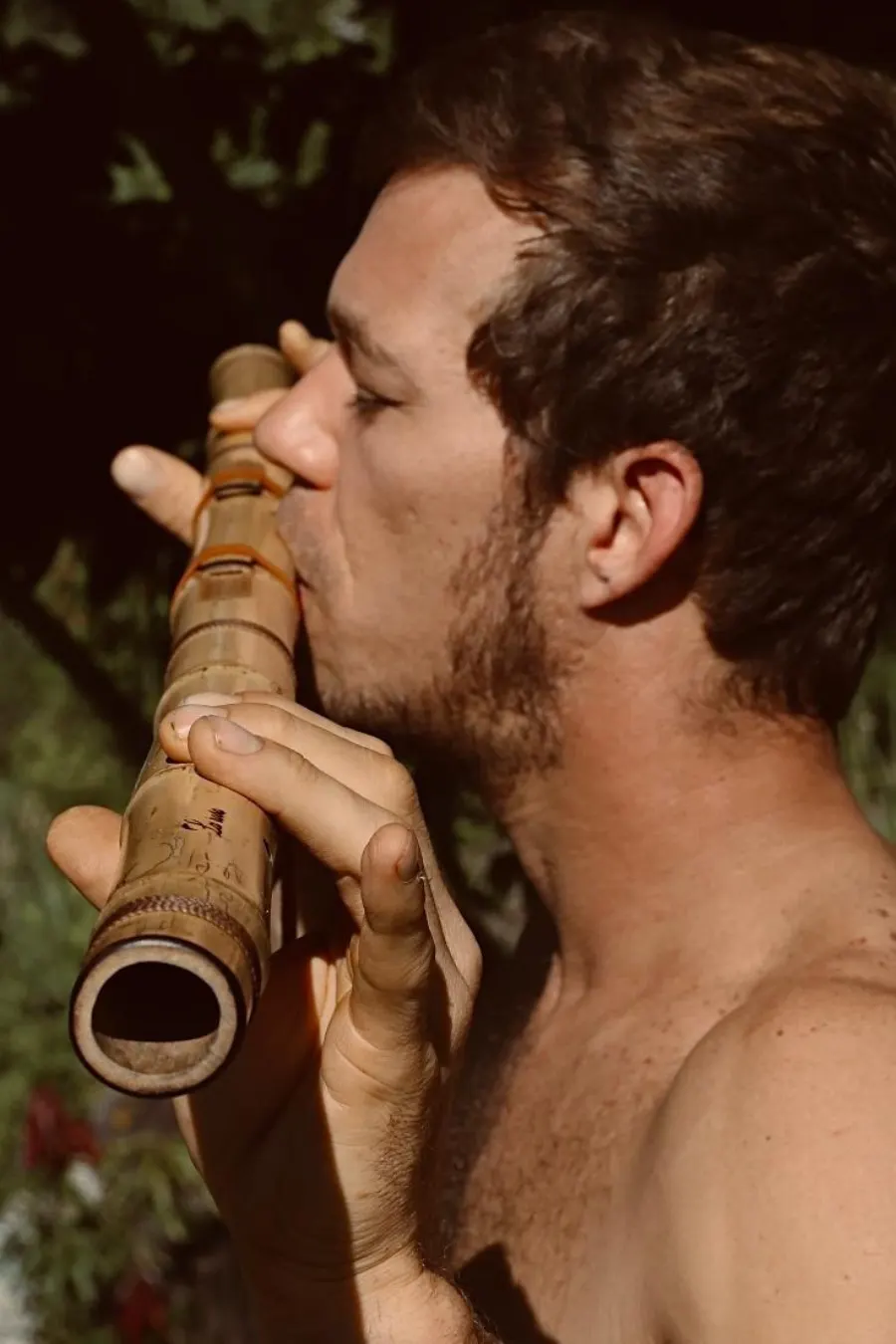Benjamin playing a bamboo flute